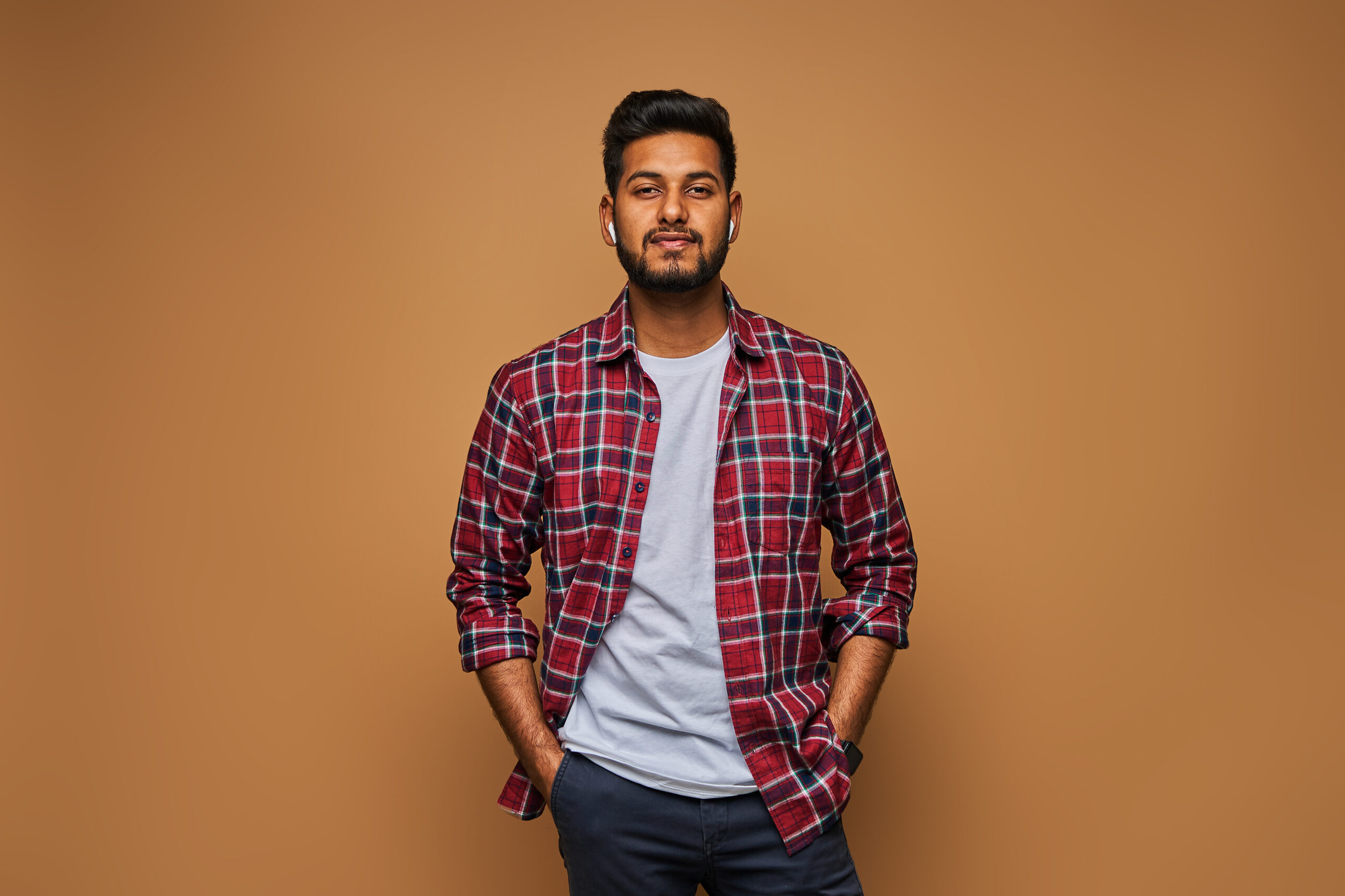 Stylish handsome indian man in tshirt on pastel background